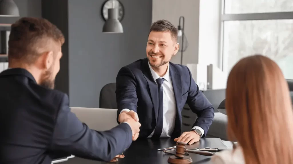 Two men in business environment compliment each other