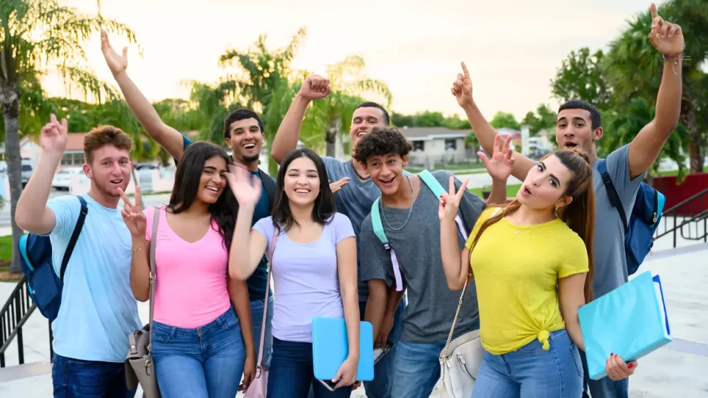 The image shows a group of smiling young students