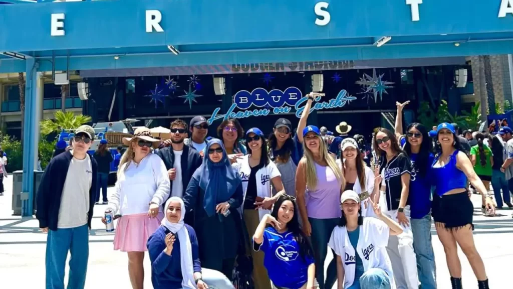 The photo shows LSI students at the entrance to the Dodgers baseball camp.