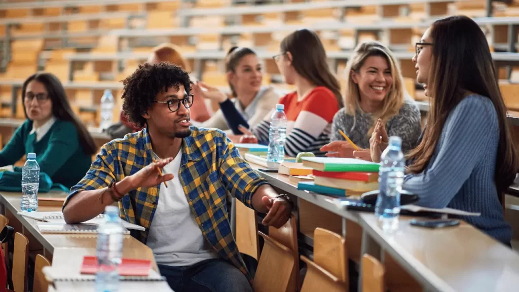 Students talking to each other about how to speak english fluently. - img how to speak english fluently lsi - Language Systems International Students talking to each other about how to speak english fluently.