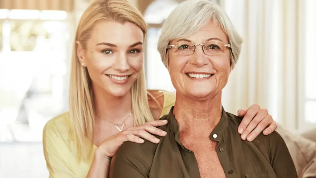 A mother and a daughter smiling