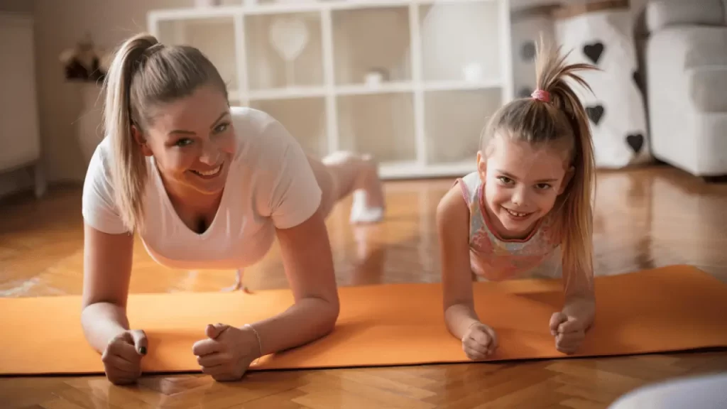 A mother and a daughter practicing yoga