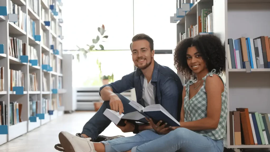 couple smiling in a library - img b planning your 2027 study abroad in the usa lsi - Language Systems International couple smiling in a library